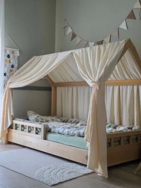 Natural cotton canopy for toddler bed, creating a cozy, dreamy space in a Montessori nursery | YokoTower